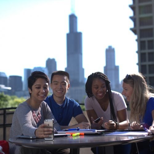 Group of students with city skyline in background